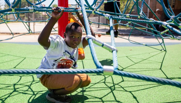 A boy poses with new play equipment at C.B. Moore Recreation Center