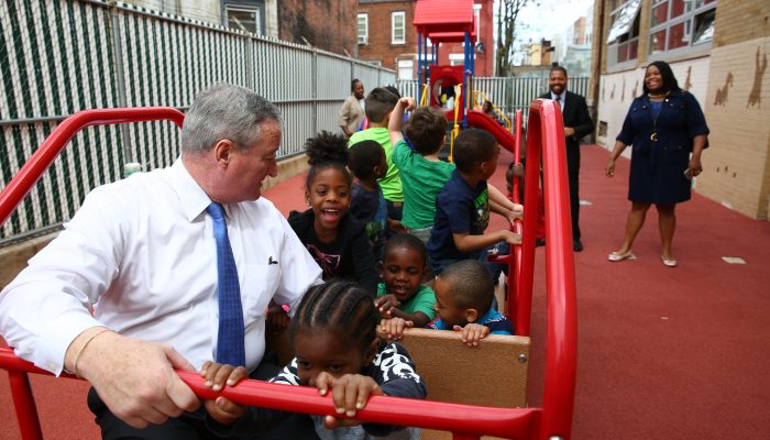 Mayor Jim Kenney spends time with children playing on playground