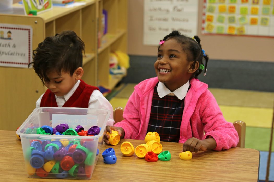 PHLpreK student plays looks up and smiles