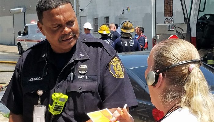 Firefighter interacts with resident after fire.