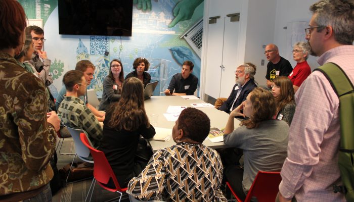 Participants in the Office of Sustainability's Powering Our Future visioning session gather around a table