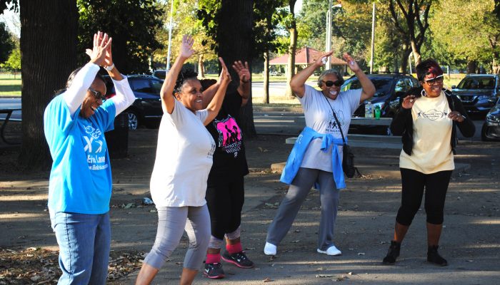 A group of ladies stretching to get ready for a walk