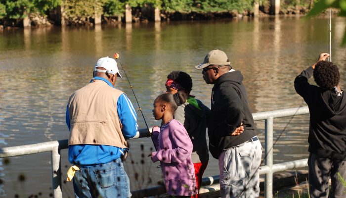 A family fishing by the river