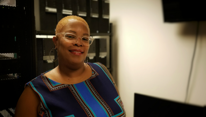 Toni Curtis-Ford, from the Office of Innovation and Technology, standing in front of an array of computer servers.