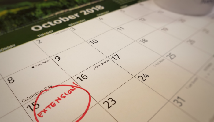 The word Extention is written and circled on the October 15 date on a calendar