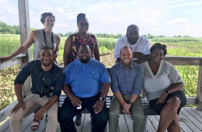 Community Schools Coordinators sit together and smile at John Heinz National Wildlife Refuge at Tinicum