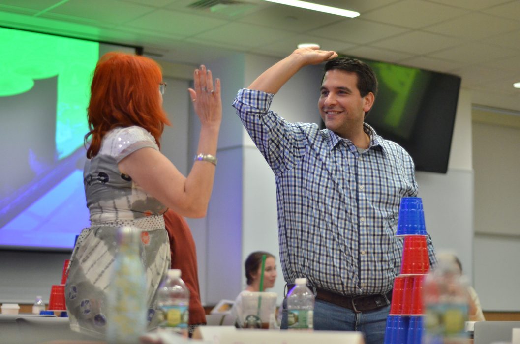 man and woman slapping hands and smiling