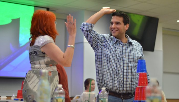 man and woman slapping hands and smiling