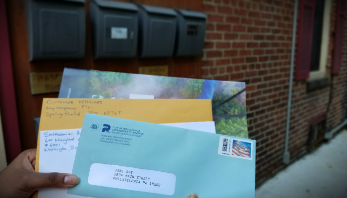 A Philadelphia water bill among a stack of letters received in the mail