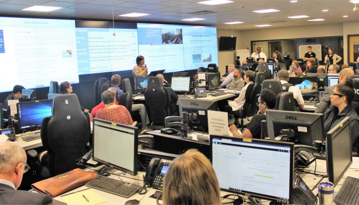 Dozens of City staffers sitting in the City's Emergency Operations Center.