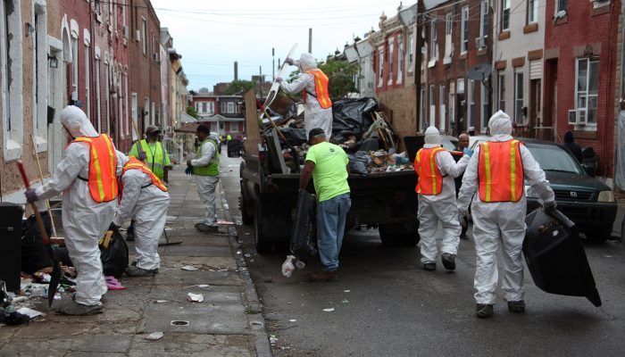 Men cleaning up a street