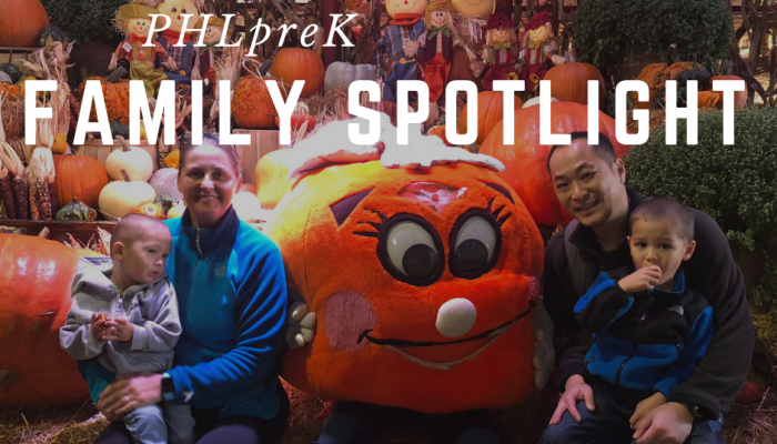 PHLprK student Jackson sits with his family at a pumpkin patch and smiles