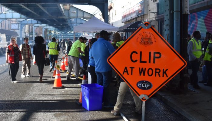 A group of workers cleaning Kensington Ave.