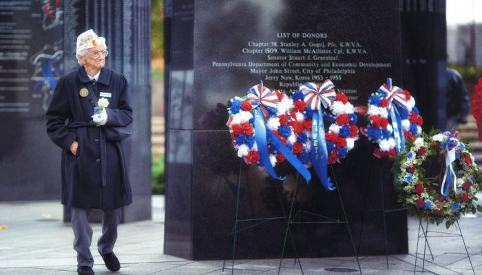 woman veteran walking near memorial