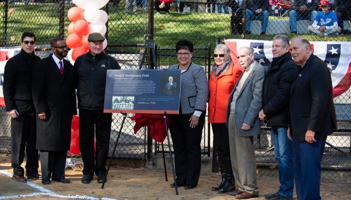 Officials stand with David Montgomery at field renaming