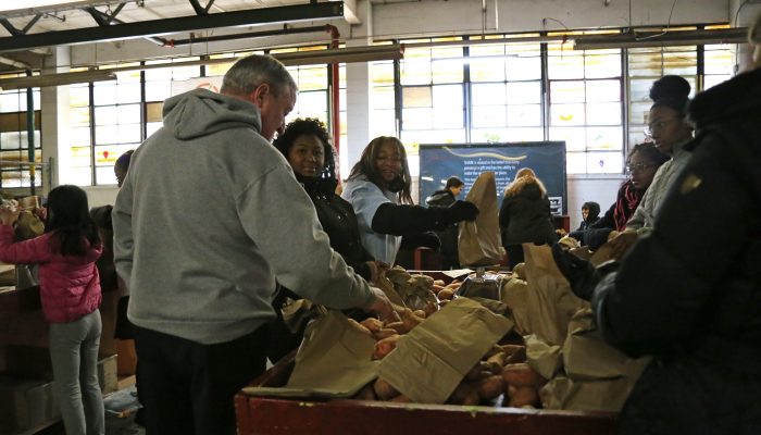 photo of volunteers packing bags of food