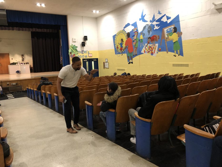 Gideon Community School Coordinator Greg Wright high fives a student