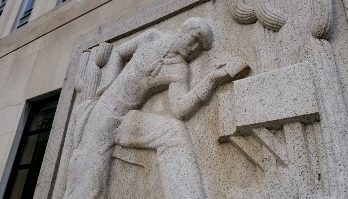 An entrance to the Federal Building in Center City, Philadelphia features a relief of a cowboy retrieving a letter from a mailbox