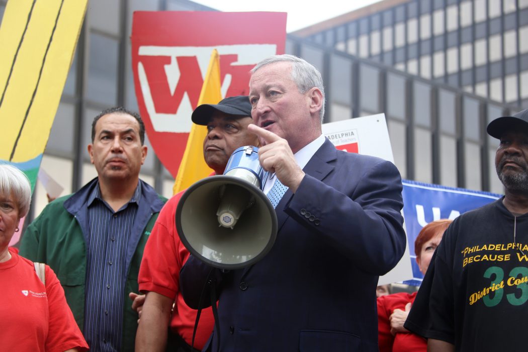 Mayor Kenney pointing his finger as he speaks holding a bullhorn with members of City municipal unions at a labor rally.