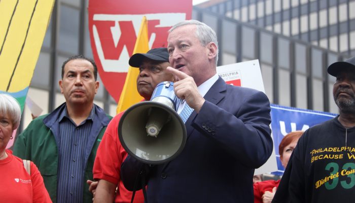 Mayor Kenney pointing his finger as he speaks holding a bullhorn with members of City municipal unions at a labor rally.