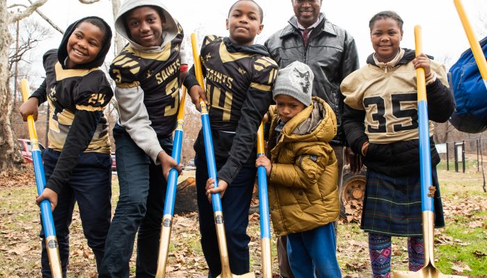six children holding shovels in dirt at Parkside fields