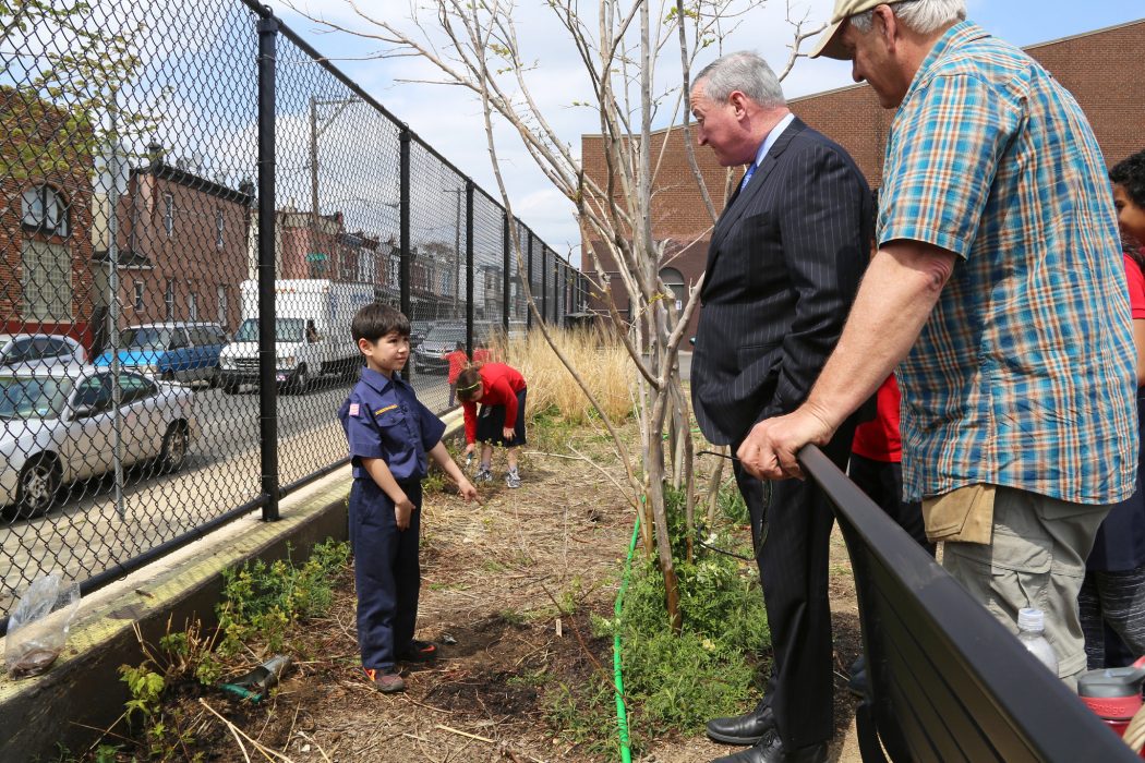 Mayor Kenney speaks with a student in the garden at Cramp Elementary School