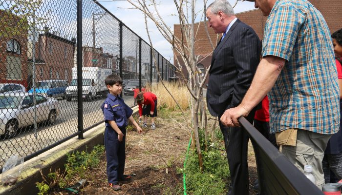 Mayor Kenney speaks with a student in the garden at Cramp Elementary School