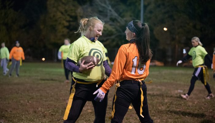 Two athletes on the field at Tarken Playground, playing flag football