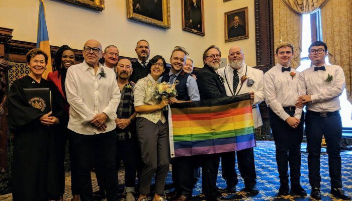 couples pose with more color more pride flag