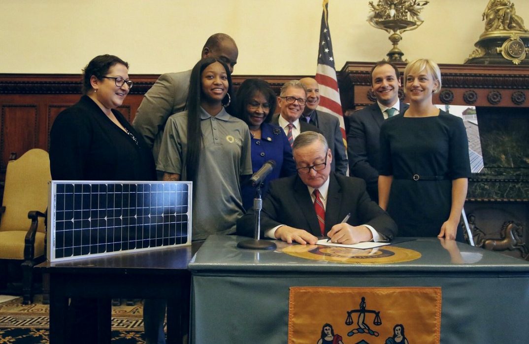 Mayor Kenney signing the power purchase agreement under which municipal buildings will receive 22% of their electricity from renewable sources.