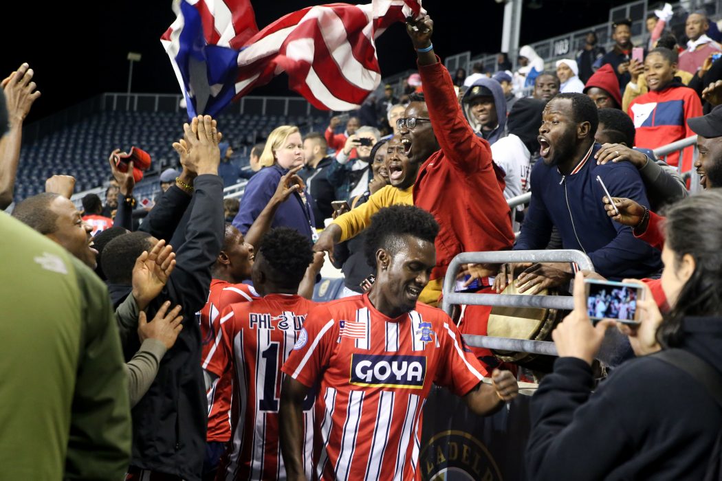 Players and fans of Team Liberia celebrate their victory over Team Ivory Coast in the Philadelphia International Unity Cup Championship on October 13.