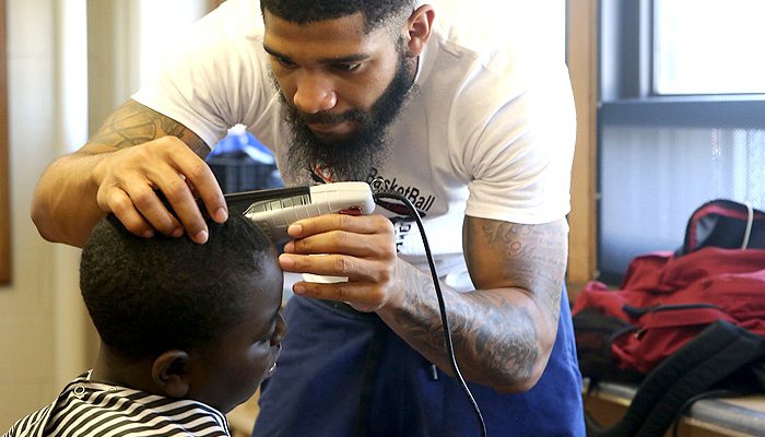 Man gives boy a haircut.