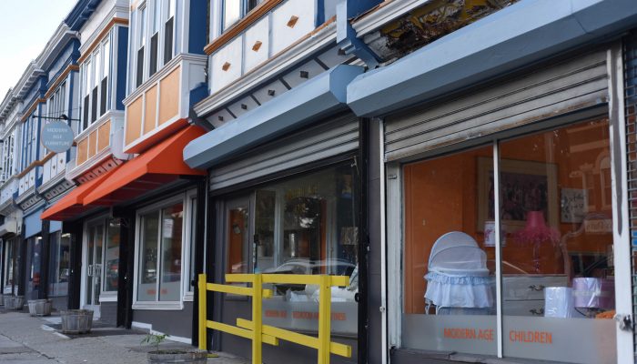 The exterior of multiple storefronts of Modern Age Furniture, a home decor shop in North Philadelphia.