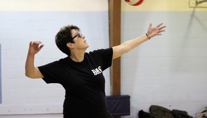 A woman about to hit a volleyball