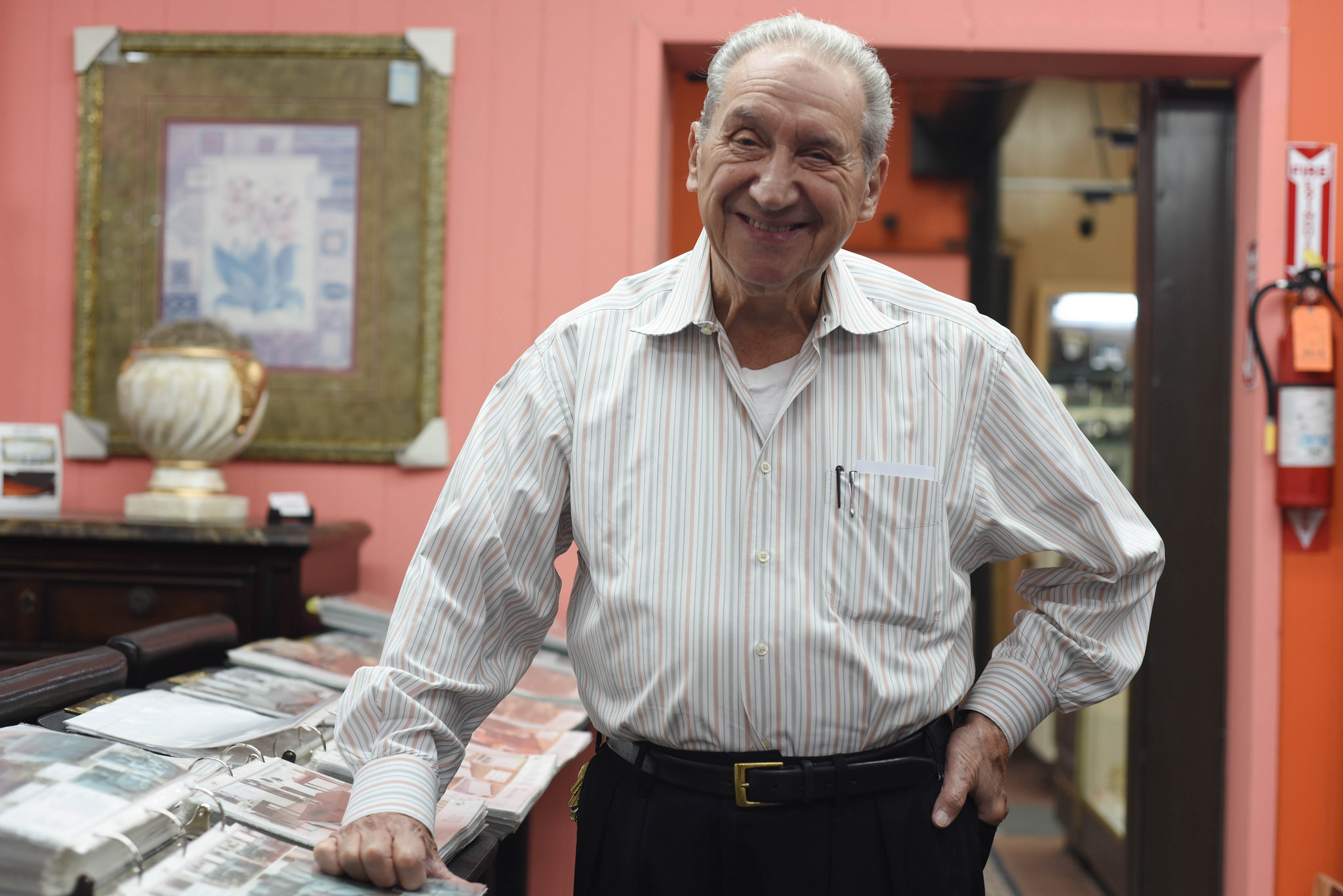 Moises Shienbaum stands inside the home decor shop he's owned for more than 50 years.