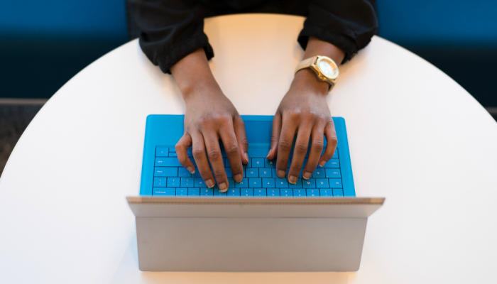 Overhead view of a woman typing on a laptop computer