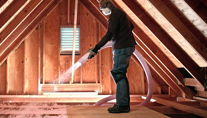 Workman installing insulation