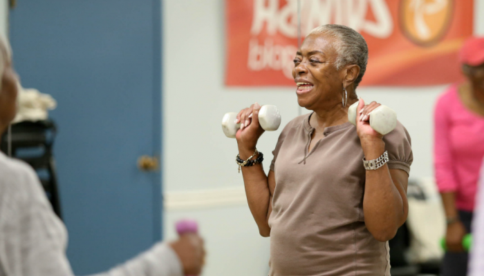 A senior citizen participates in an aerobics class