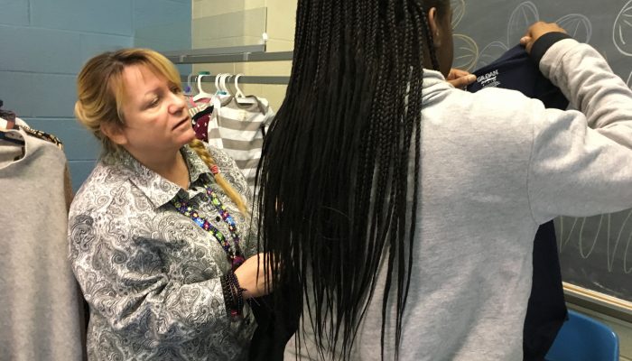 Kim Britt, George Washington High School climate support staff, helps a parent shop for clothing