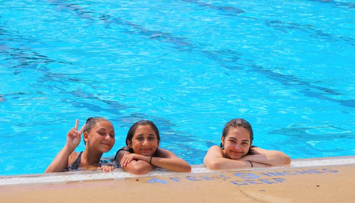 Three young girls swimming in the pool at Murphy Rec Center