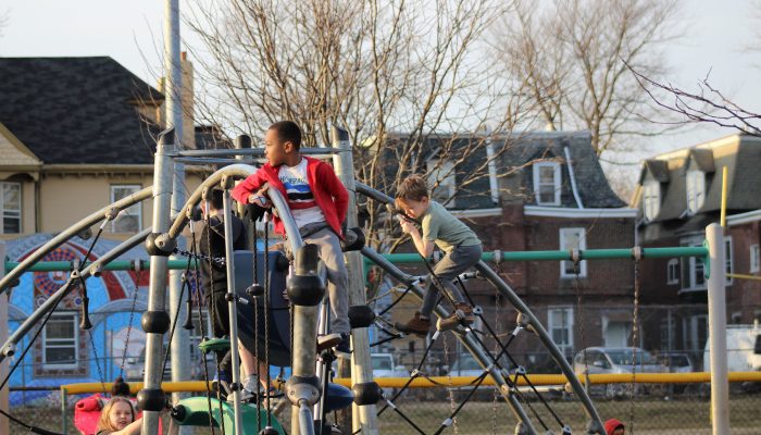 Kids climbing a jungle gym at a city playground