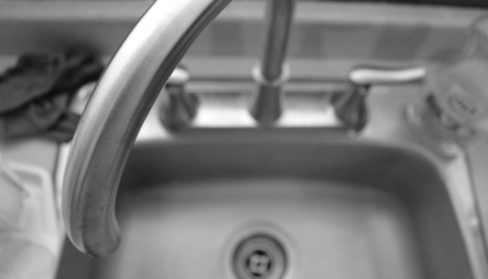 A close up of a household sink and faucet