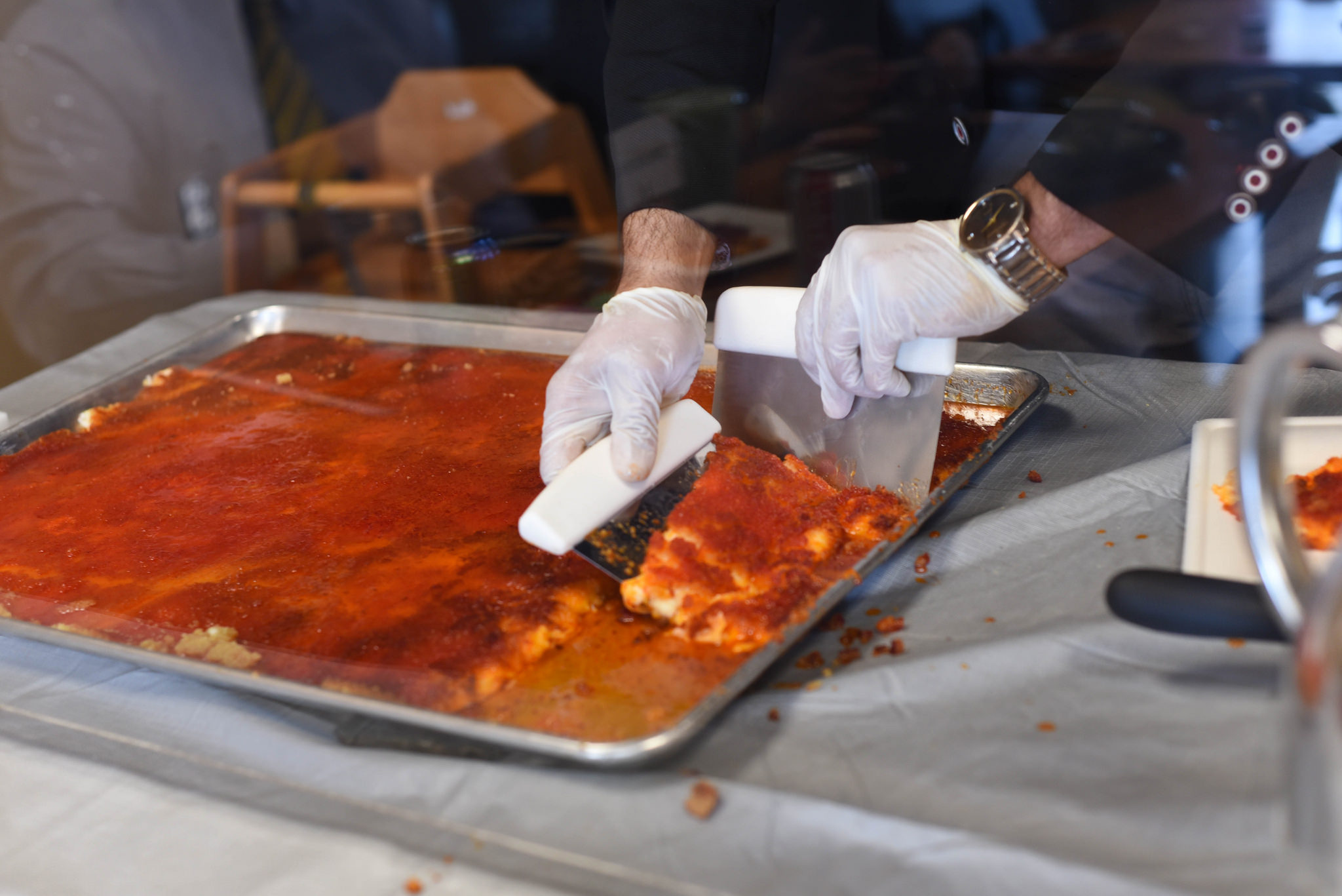 Bishara Kuttab serves knafe, a Middle Eastern dessert.