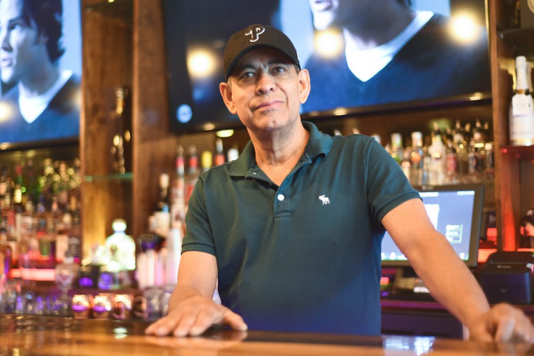 Sal Nunez stands behind the bar at his restaurant, Buccann.
