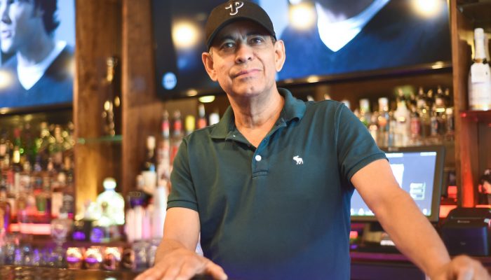 Sal Nunez stands behind the bar at his restaurant, Buccann.