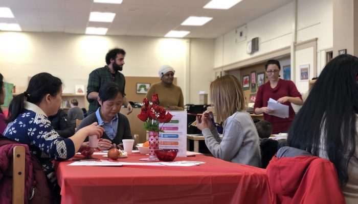 Parents at Southwark's parent cafe sit together eating and chatting about their experiences as parents.