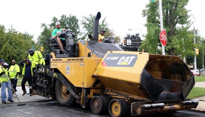 Large paving vehicle fixing a city street