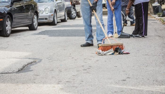 Someone sweeping litter on the street