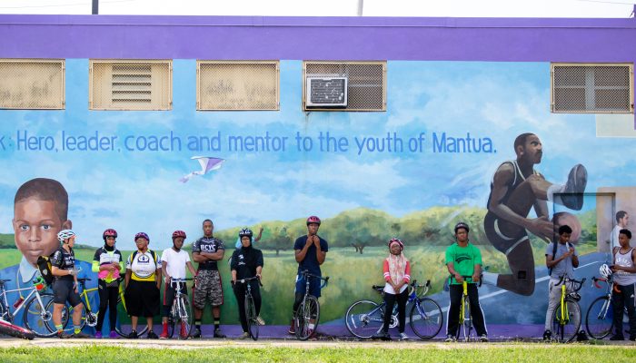 Community members in front of mural at Miles Mack Playground