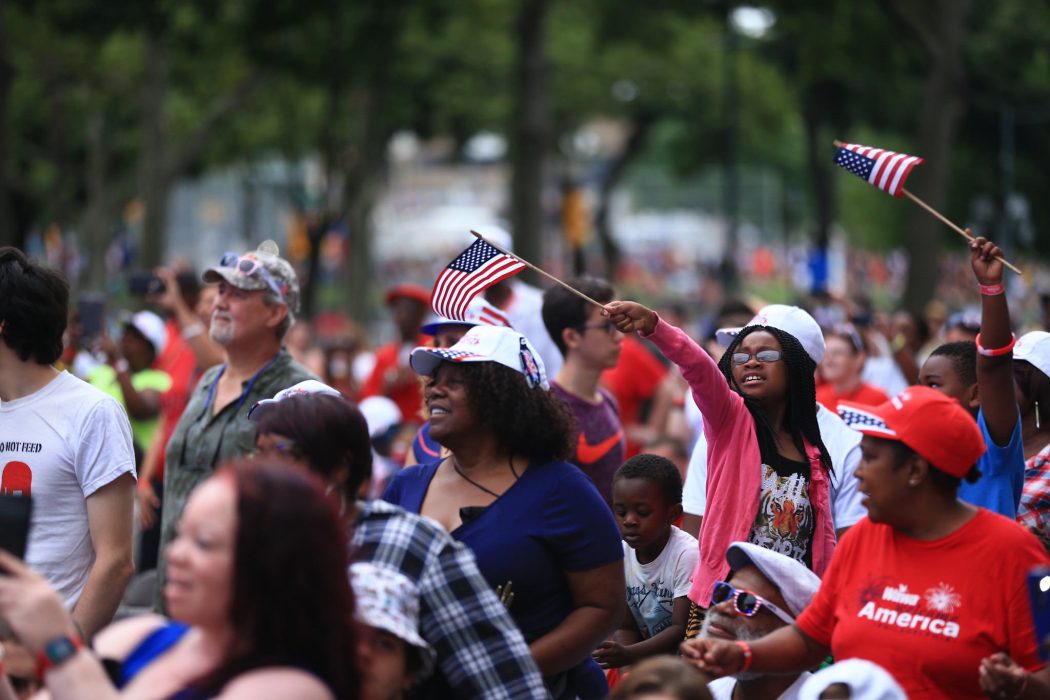 group of people waving american flags